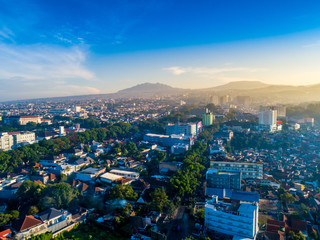 Obraz premium Aerial View of Bandung Cityscape, with Mount Tangkuban Parahu in the Background