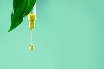Drop oil serum collagen moisturizer for face on a clear soft light background. Vitamin C. Beauty...