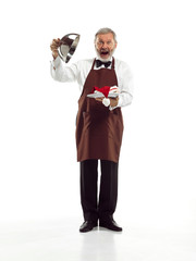Senior waiter holding tray with Santa hat and standing isolated on white studio background. concept of good service and christmas, claus, happy holiday,