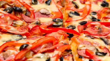 Pizza with salami, cheese and red pepper. Selective focus