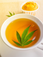 Breakfast with sweet cookies. tea with marijuana. Cannabis leaf is brewed in herbal decoction to treat pain and increase appetite. concept of marijuana use for medicinal purposes.