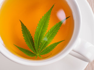 tea with marijuana. Cannabis leaf is brewed in herbal decoction to treat pain and increase appetite. concept of marijuana use for medicinal purposes.