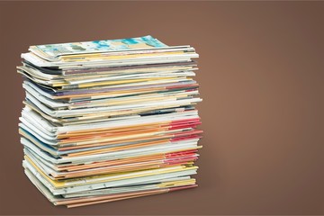 Pile of newspapers on white background