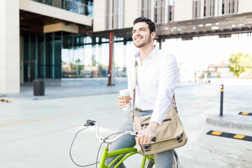 Smiling Executive With Coffee And Cycle On Street