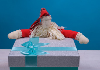 raggedy Santa Claus with gift box