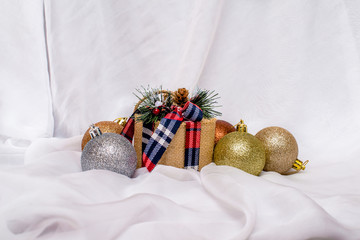 New Year's toys and a gift lie on a white cloth 