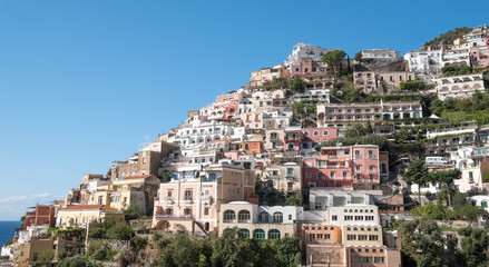Fototapeta na wymiar Colourful houses on the mountain side in the delightful town of Positano on the Amalfi Coast in Southern Italy. Photographed on a clear day in early autumn.