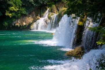 Fototapeta premium Waterfalls among green plants in Krka National Park, Dalmatia, Croatia