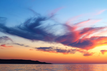 beautiful sunset clouds in the sky over the sea, bright colors of sunset