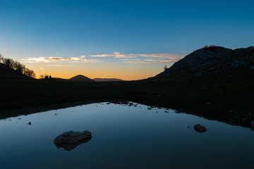 lake at sunset in the Matese mountains, Molise, Italy