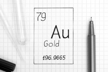 Handwriting chemical element Gold Au with black pen, test tube and pipette.