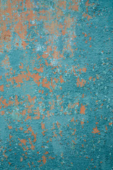 Vertical background old cracked paint on fence, primer orange, peeling paint green
