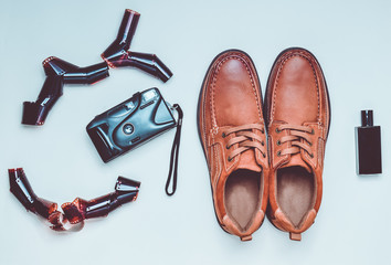 Men's leather shoes, film camera on a pastel background. Male style. Hipster look..
