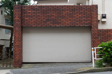 A closeup shot of automatic metal roller door used in factory, storage, garage, and industrial warehouse. The corrugated and foldable metal sheet offer space saving and provide urban and rustic feel