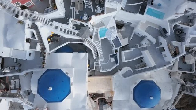 Top aerial view of Three Blue Domes church in Oia town on Santorini island, Greece