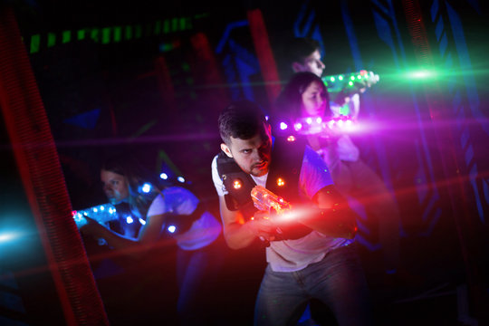 Guy in colored beams during laser tag game