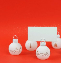 Christmas background from white Christmas balls and frame mock up on red  background . Xmas composition of New Year's Christmas balls. Winter holiday concept.Flat lay. Top view. Copy space