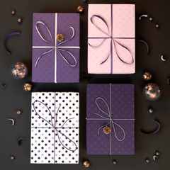 Christmas gifts in purple and pink colors. Beautiful Christmas boxes with gifts. 3D illustration.