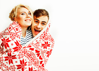 young pretty teenage couple at Christmas time warming in red dec