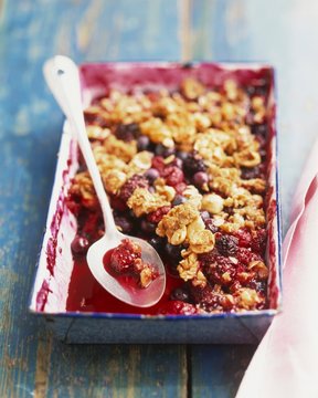 Mixed Berry Crumble in Baking Pan with Serving Spoon