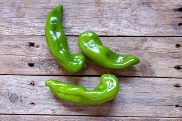 Raw green peppers on wooden rustic table