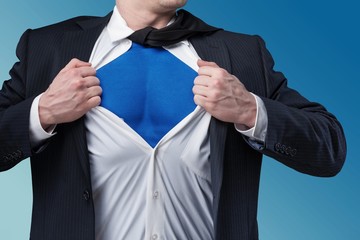 Businessman tears shirt on himself to show that he is Superman