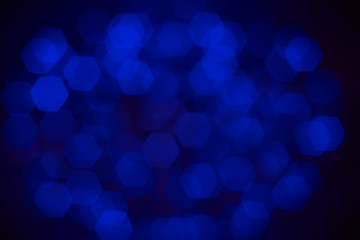 Abstract beautiful blurred electric blue hexagon bokeh from group of blacklight. Background for the mystery or sciences or dramatic concept.