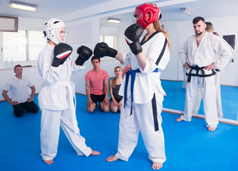 Two girls practice sparring  at tekvando