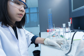 Fototapeta premium Scientist mix chemicals with The shake machine Before the experiment.Mixture laced with samples into test tubes,Thailand scientist working in the lab