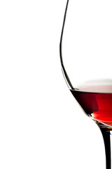 Close-up of a glass of red wine on white background.