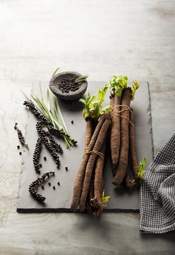 Fresh black salsify and peppercorns on the vine