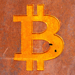 Bitcoin symbol on rusty metal background