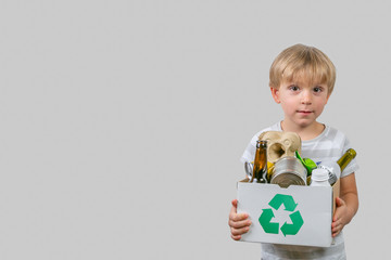 Boy holds box with recyclable materials