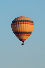 Orange hot air balloons against blue sky