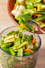 pepper and garlic are poured into a blender