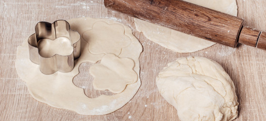 cookie cutter with dough and rolling pin