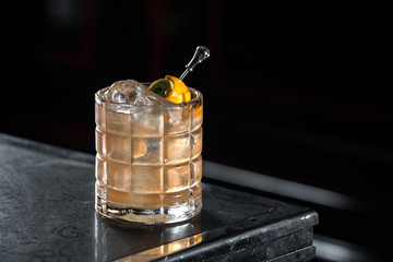 Mexican old fashion on a bar desk. black background