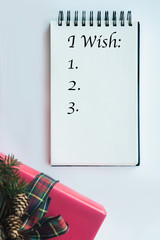 Christmas background with notebook for wish list.
