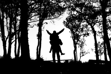 silhouette of love couple in trees border, back and white tone