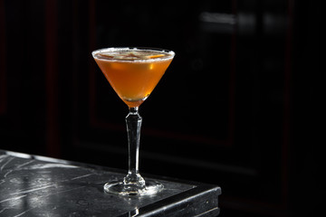 Apple Tini on a bar desk. black background.