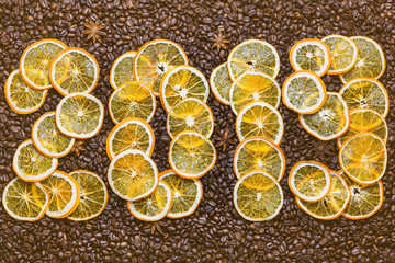 Slices of dry oranges on a coffee background. 2019 new year.