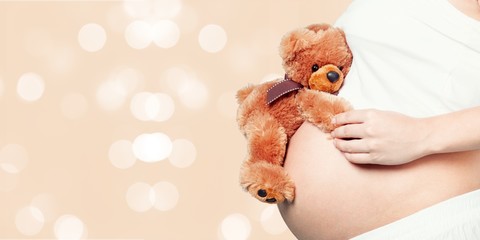 Pregnant woman in dress with red flower