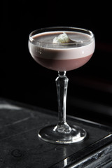 Porto Flip cocktail on a bar desk. black background
