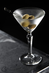 Dry Martini cocktail on a bar desk. black background