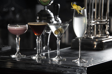 four special cocktails on a bar desk. black background