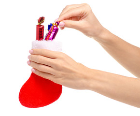 New year boot with toys candy in hand on white background isolation