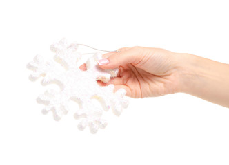 Christmas toy snowflake in hand on a white background. Isolation