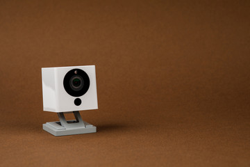 white webcam on brown background, object, Internet, technology concept
