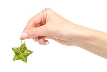 Christmas toy green star in hand on a white background. Isolation