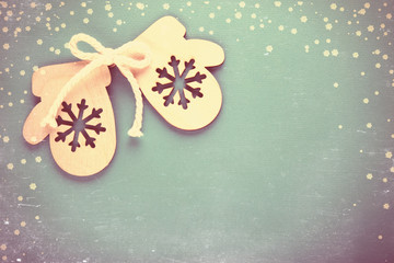 Wooden Toy mitten on a Festive background. Vintage toning and scratches.